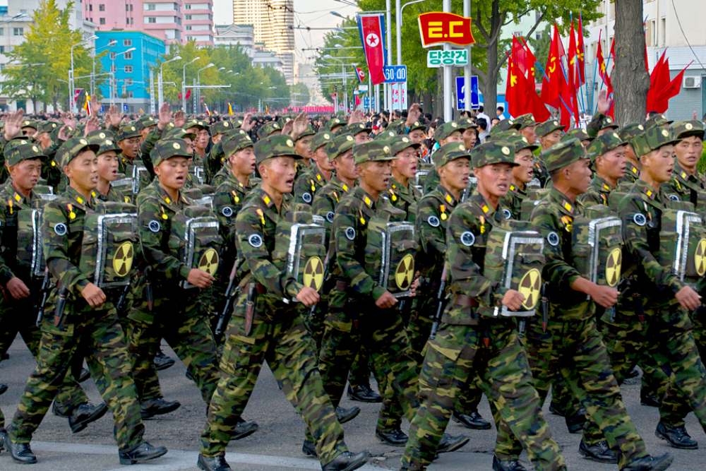 North Korean soldiers marching with nuclear signs on their chests
