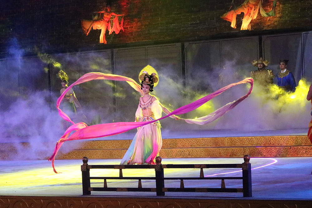 A woman dancing with long ribbon-like sleeves