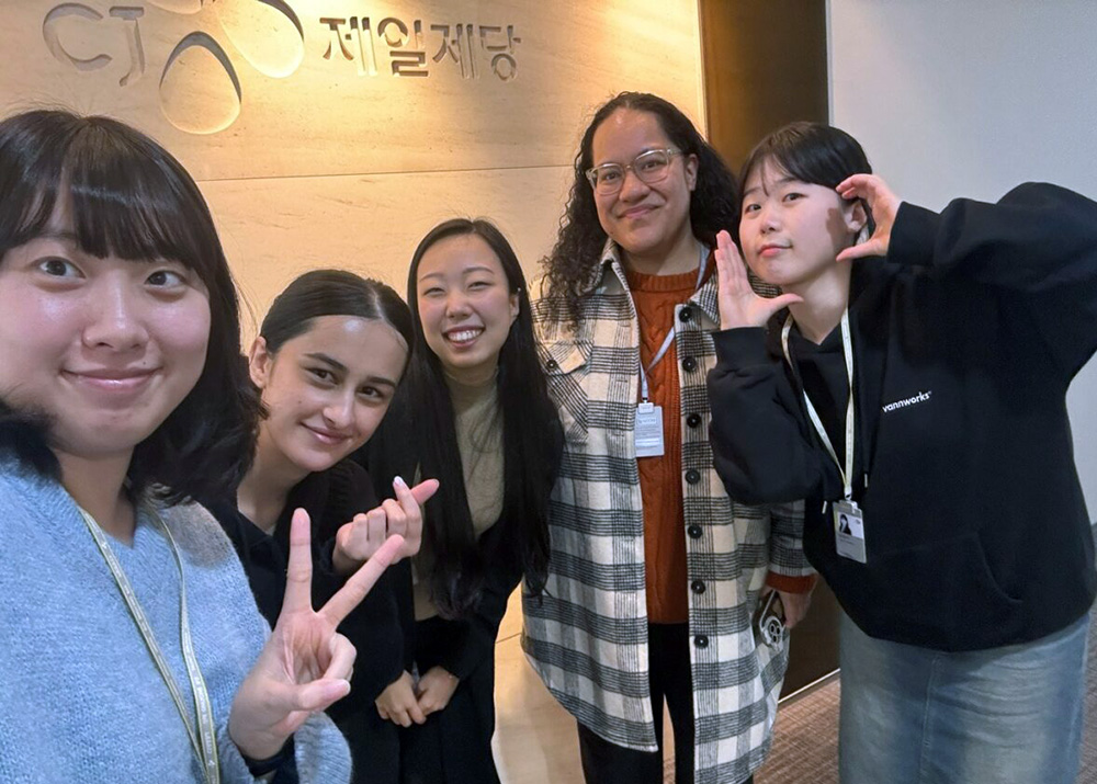 Fine and Nadia posing for a photo with colleagues in Seoul
