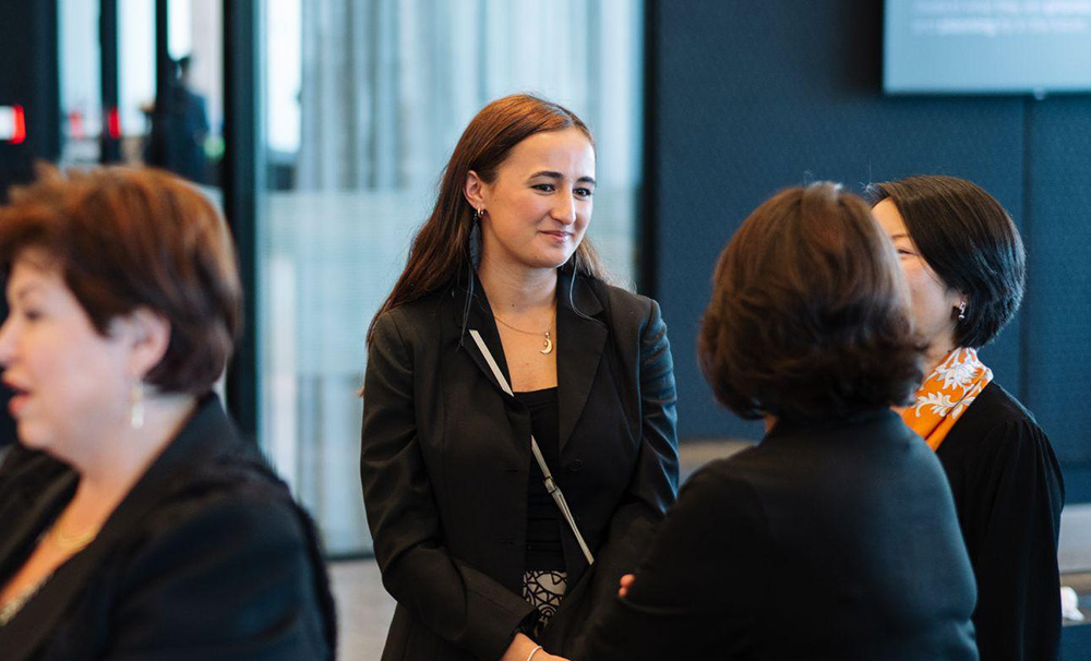 Laura talking to two women at a business event