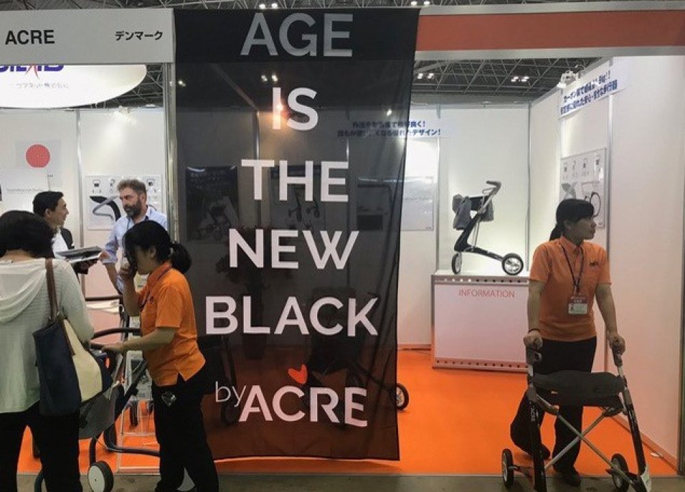 Workers work around a sign saying Age is the new black
