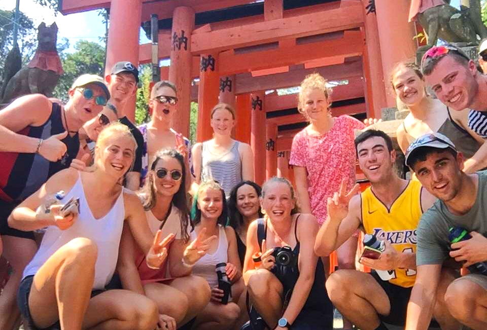 The rowers posing beneath Torii Gates (Photo courtesy of Rowing NZ)