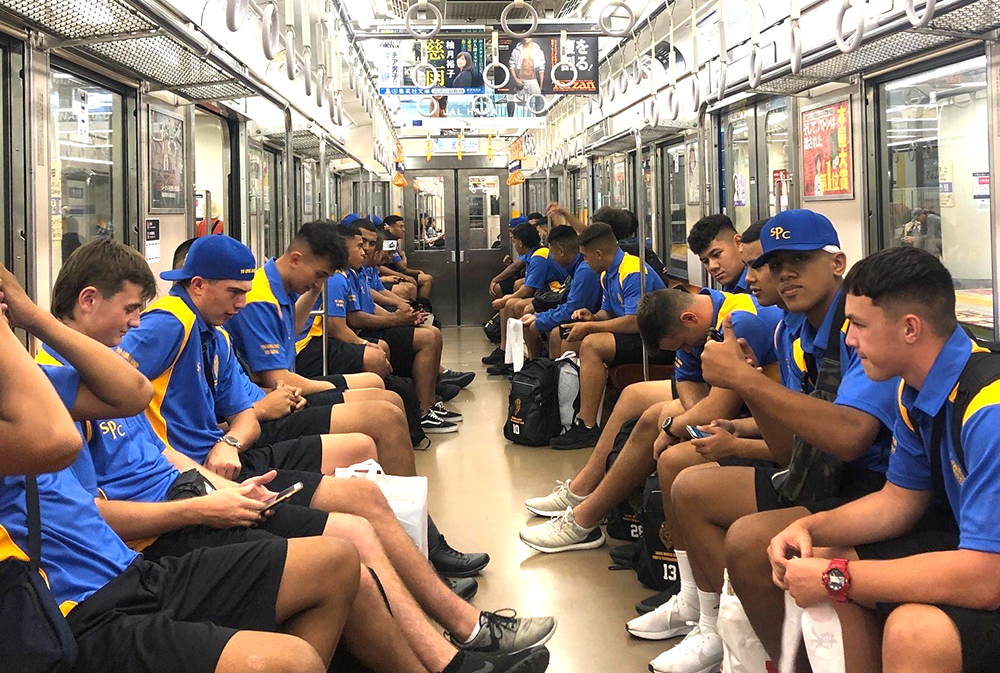 The team sitting in a subway carriage