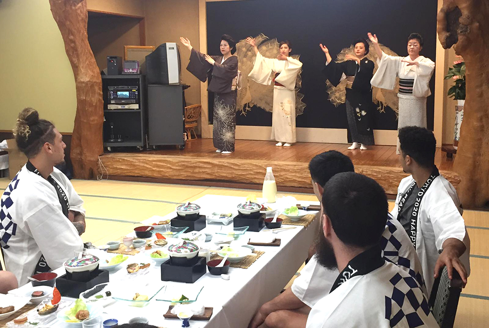 Tall Blacks players watching four women performing traditional Japanese dance