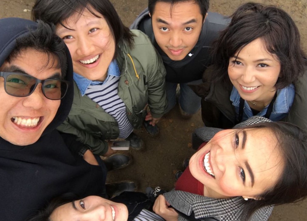 The visiting Southeast Asian entrepreneurs looking up at a camera for a group selfie