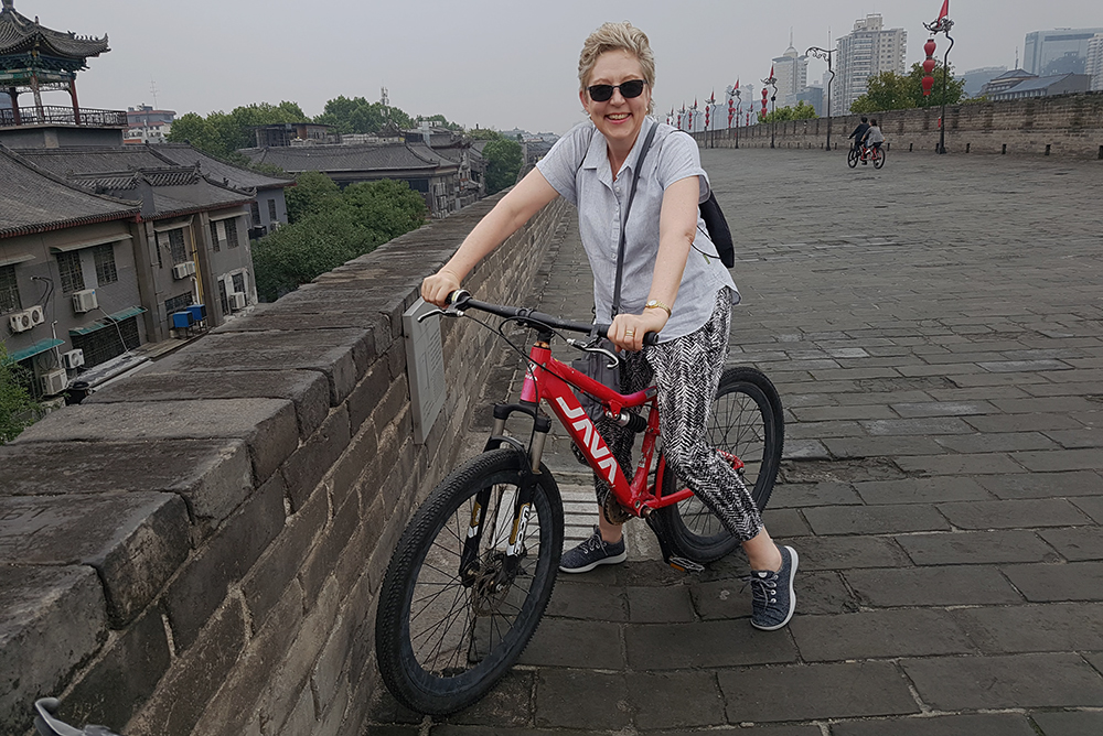 Amanda Cropp on a bike on Xi'an's city wall