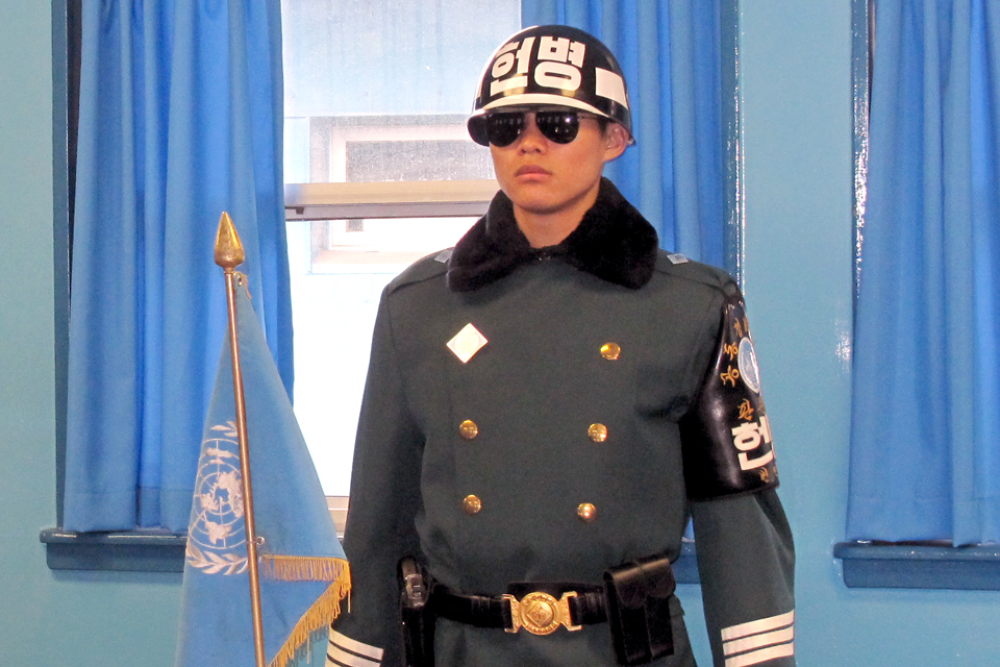 NK soldier standing to attention in full uniform