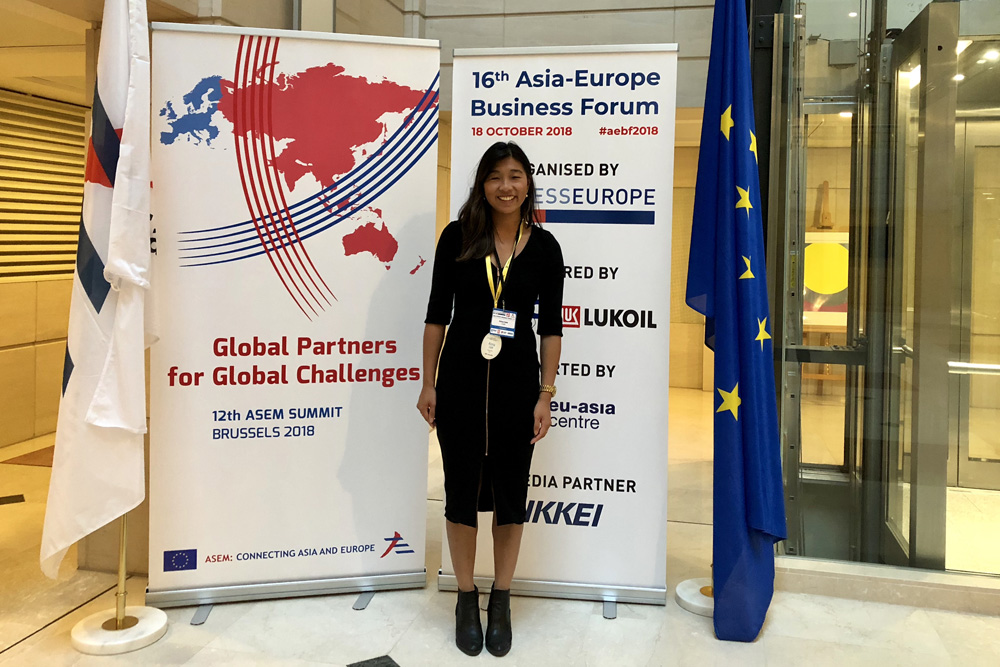 Anna standing in fron of Asia-Europe Business Forum banners