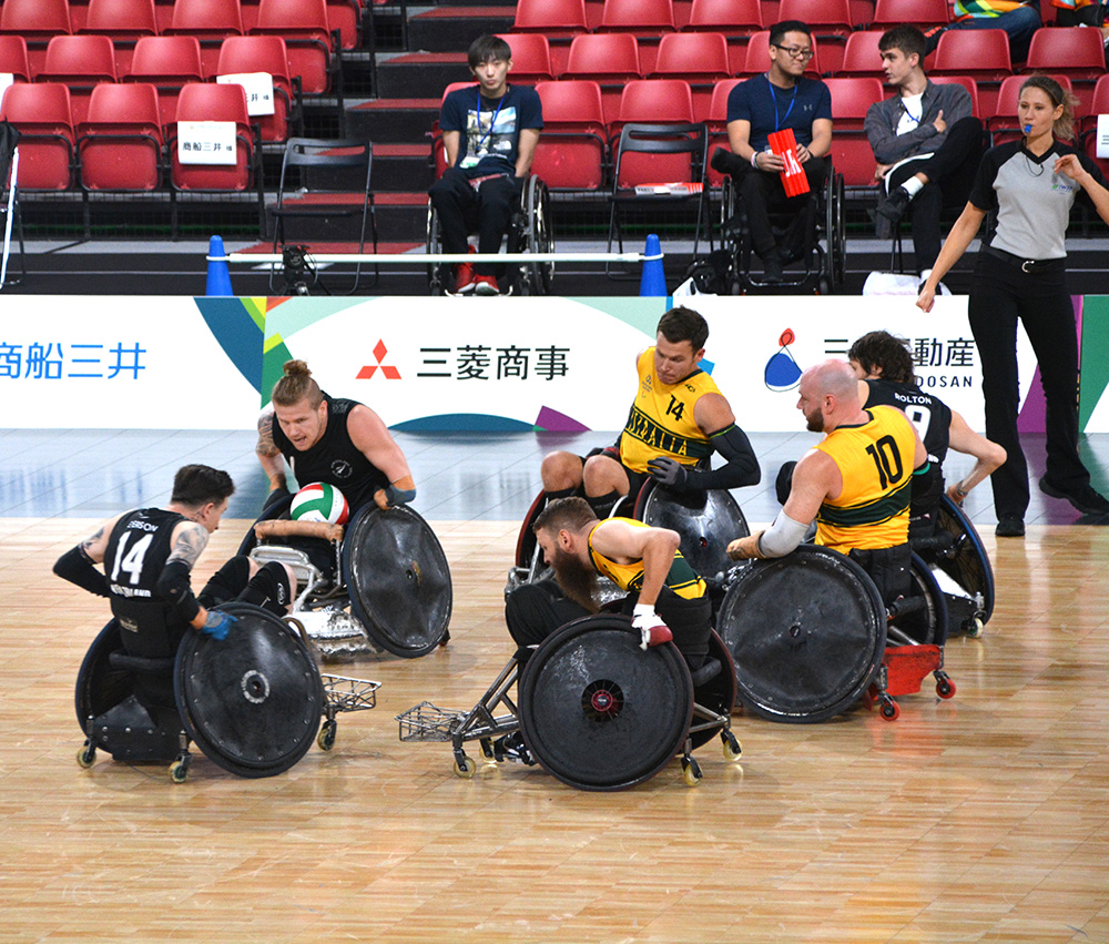 Two Wheel Blacks surrounded by Australian players