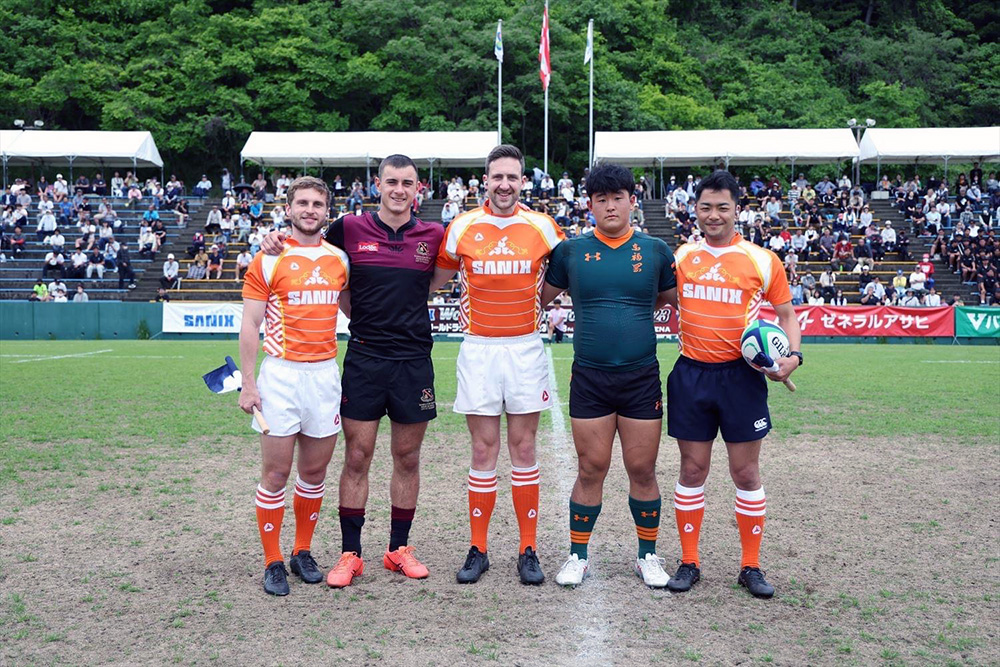 Hamilton Boys High captain, the referres and the captain of the opposing Japanese High School pose for a pre-match photo 