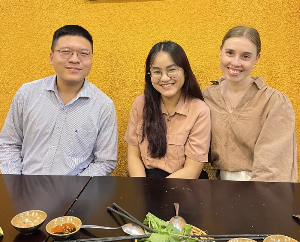 Harriet with KPMG intern and friend, Long (centre), and Long (SSG intern) and her mentor Dieu Anh with the remnants of a meal in front of them
