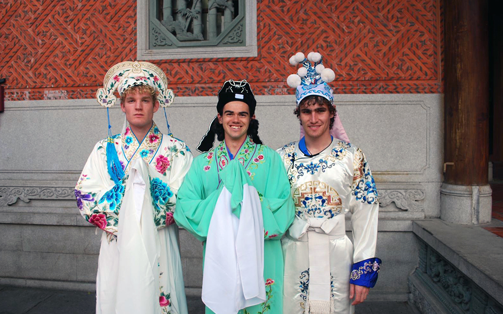 Three of the players dressed in traditional dress of the region