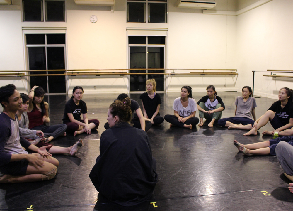 Sarah talking to a group of young dancers in a circle