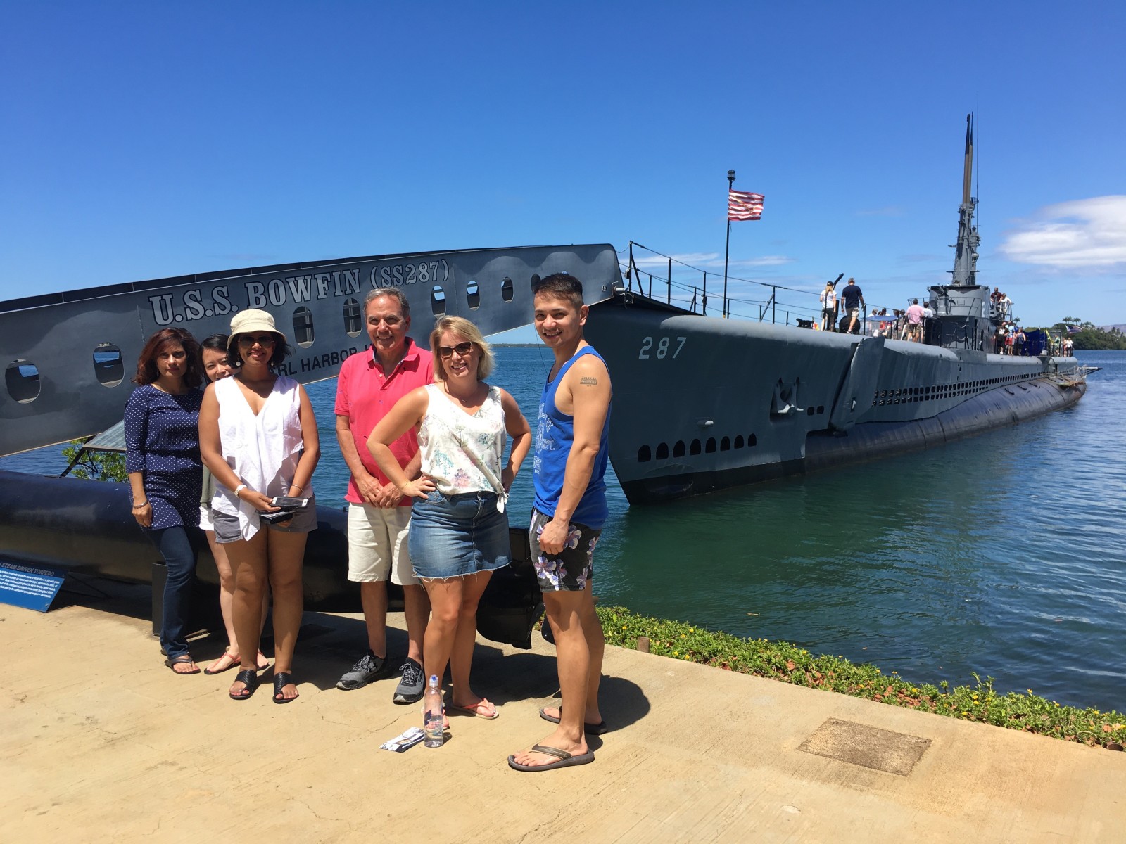 group standing in front of the Pearl Harbour Memorial