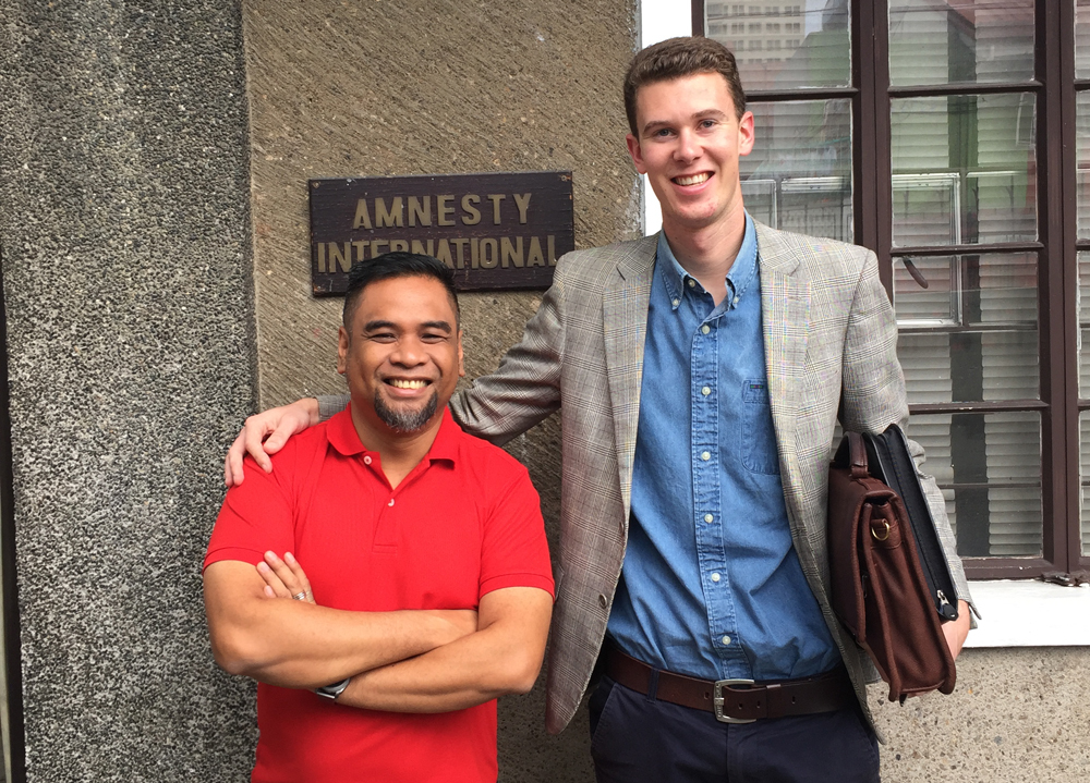 Daniel posing with man outside Amnesty international