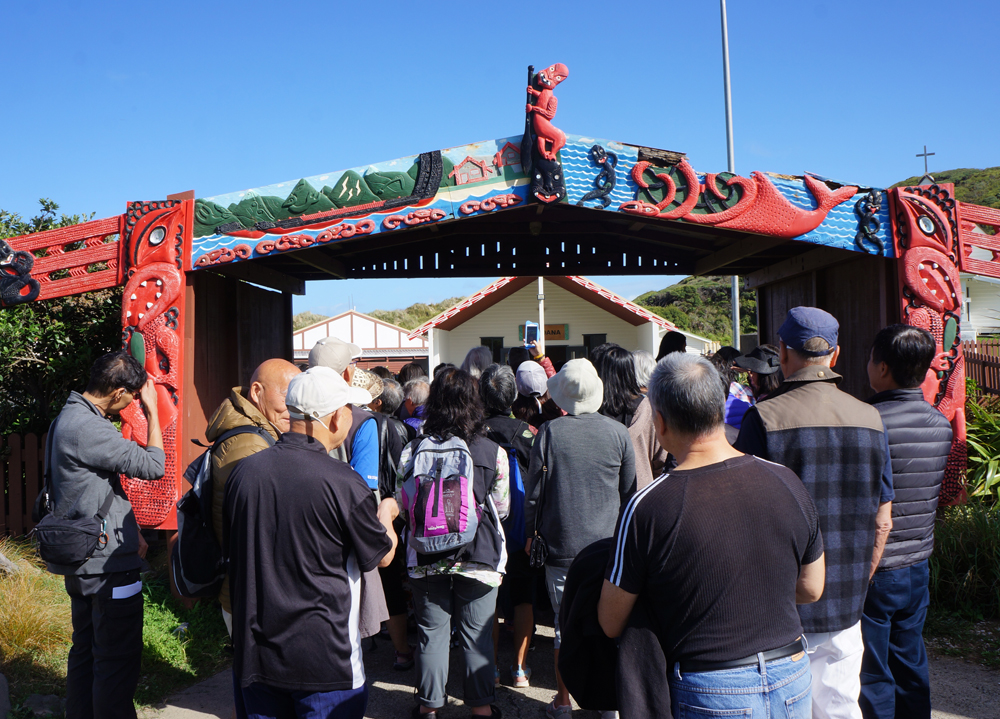 Group of people heading into a Marae throuhg the entrance