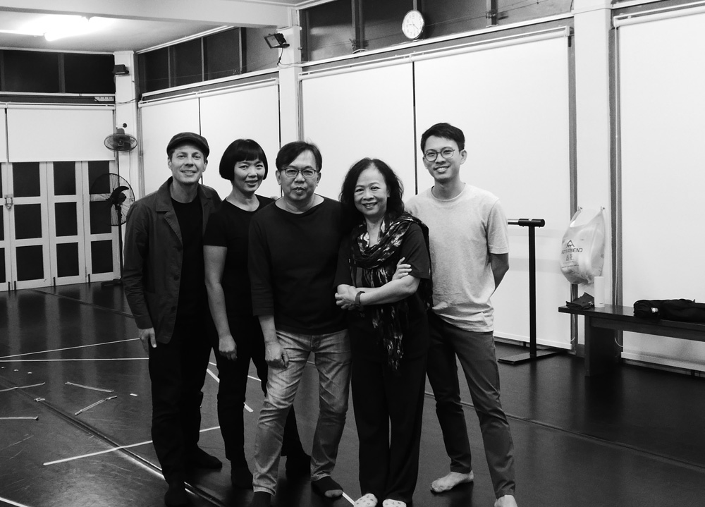 daniel standing with other members of the arts dance company in Singapore