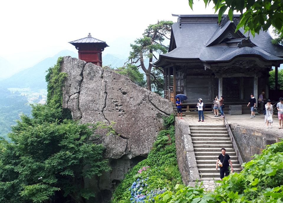 Photo of picturesque mountainside with Japanese style structure on it