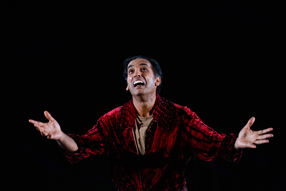 Rajan on stage in a red robe