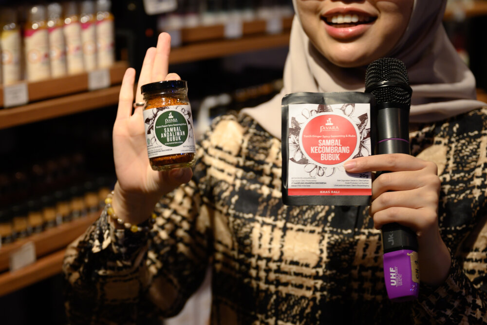 Awoman holding a microphone and beauty products