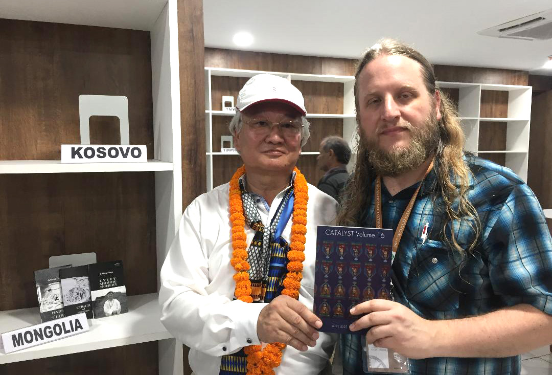 Docheller and a fellow poet holding a copy of poetry magazine Catalyst