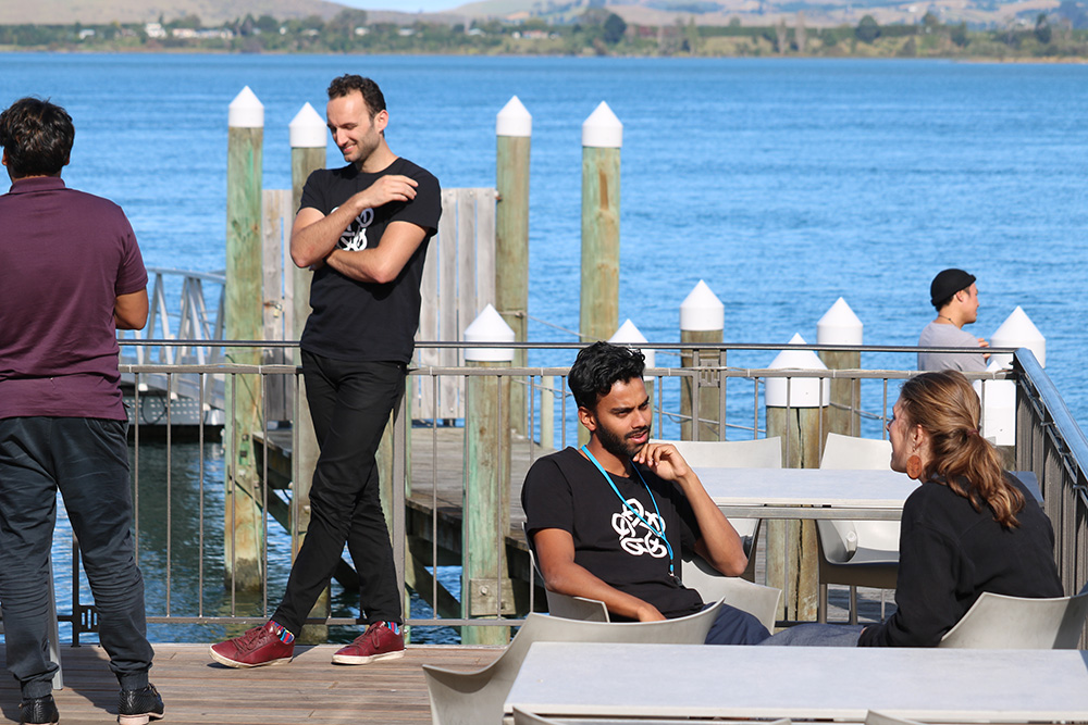 Two pairs of hui participants chatting on a wharf