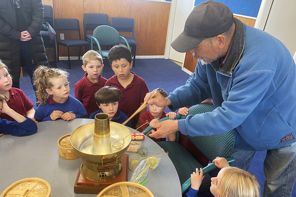 Ling's father Jacques Li showing kids how a steamboat steamer works