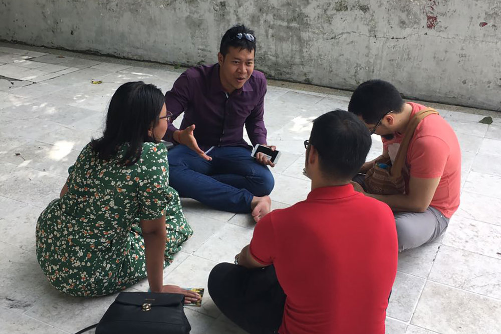 Four YBLIs from Myanmar sit in a circle and discuss tough topics