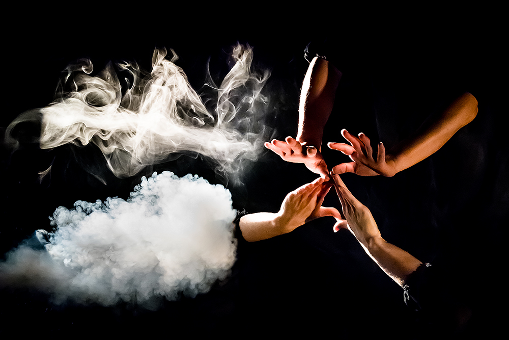 An image of hands and smoke
