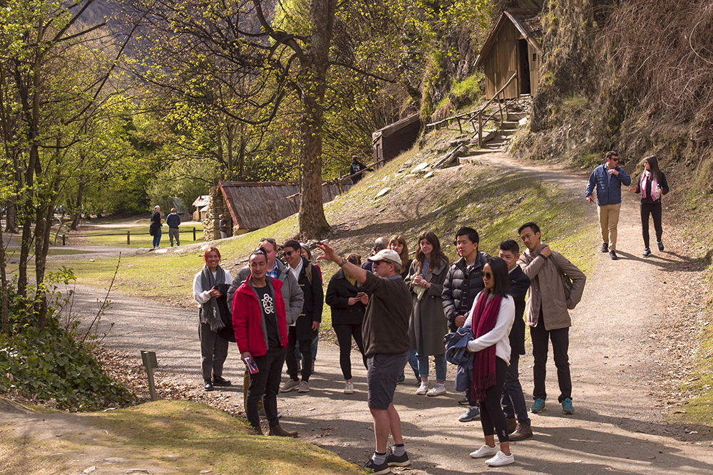 A group of Leadership Network members at the historic Chinese camp in Arrowtown listening to a man talking