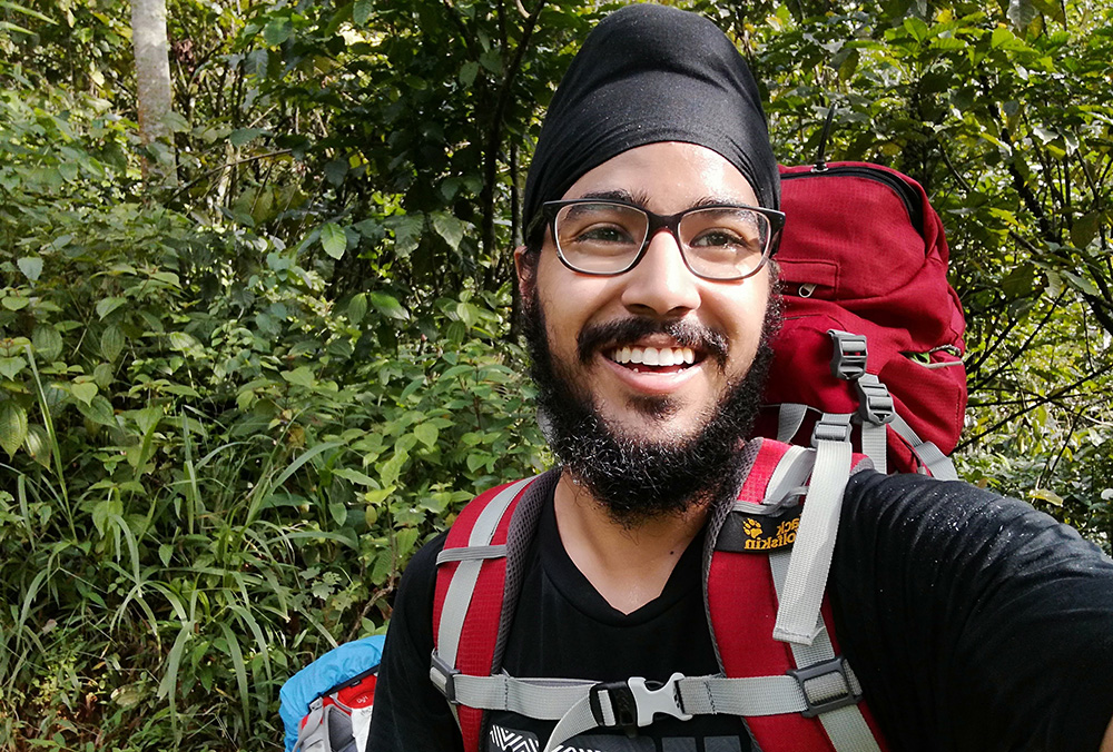 Parneet with a backpack on in the bush