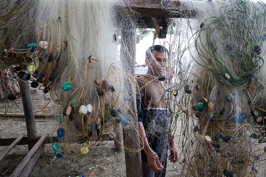 A man standing behind a fishing net