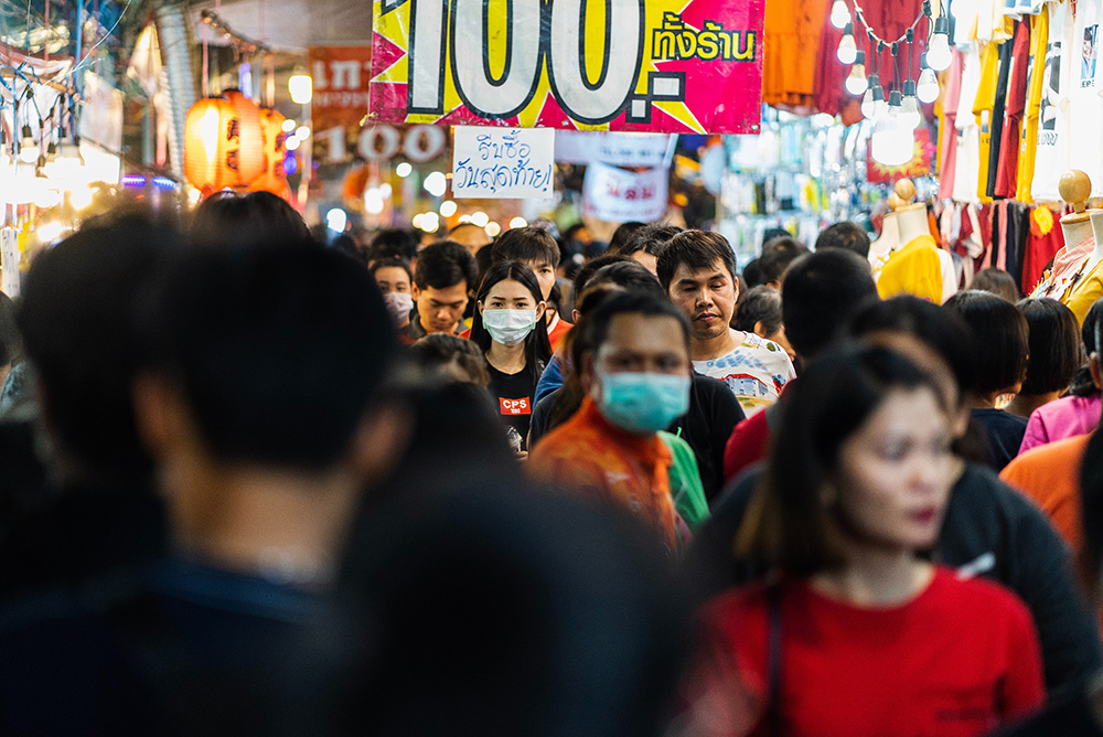 People wearing masks in a busy nightmarket