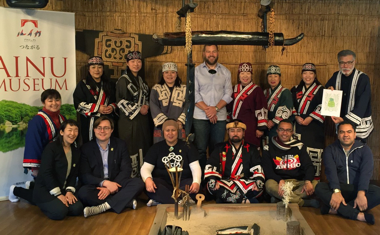 Shannon (standing centre) with fellow Maori delegates with Ainu dressed in traditional clothes  