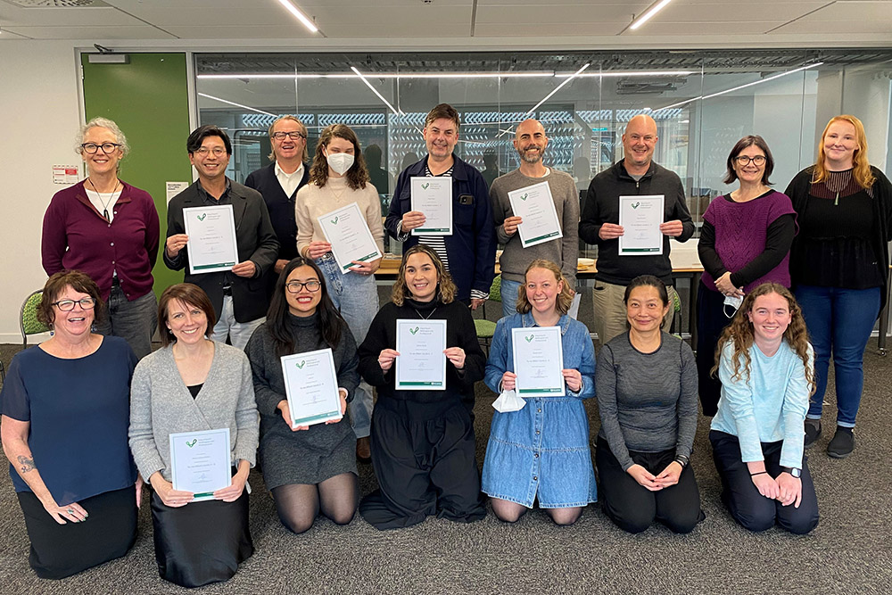 Foundation staff members and Victoria University staff holding certificates of completion for their te reo  Māori course