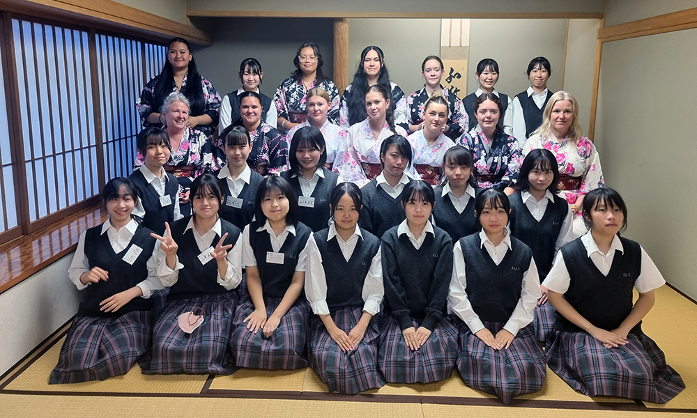 The Waihi College students (dressed in kimono) and Japanese students in a traditional Japanese room with tatami mats