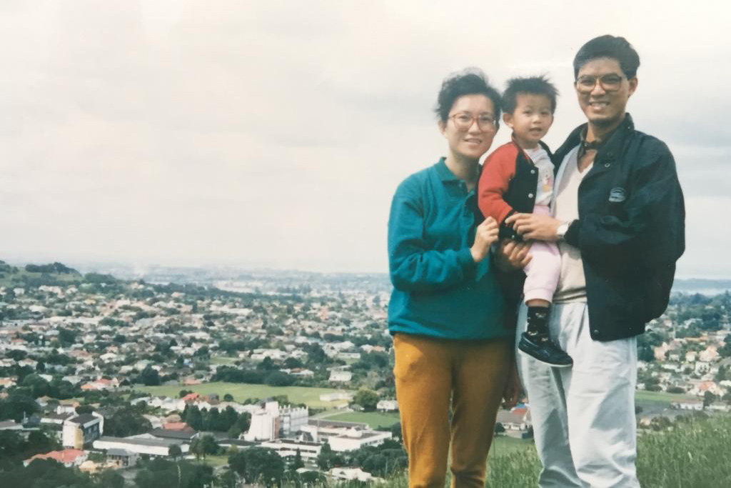 Wilson as a young boy with hs parents on a hill overlooking Auckland