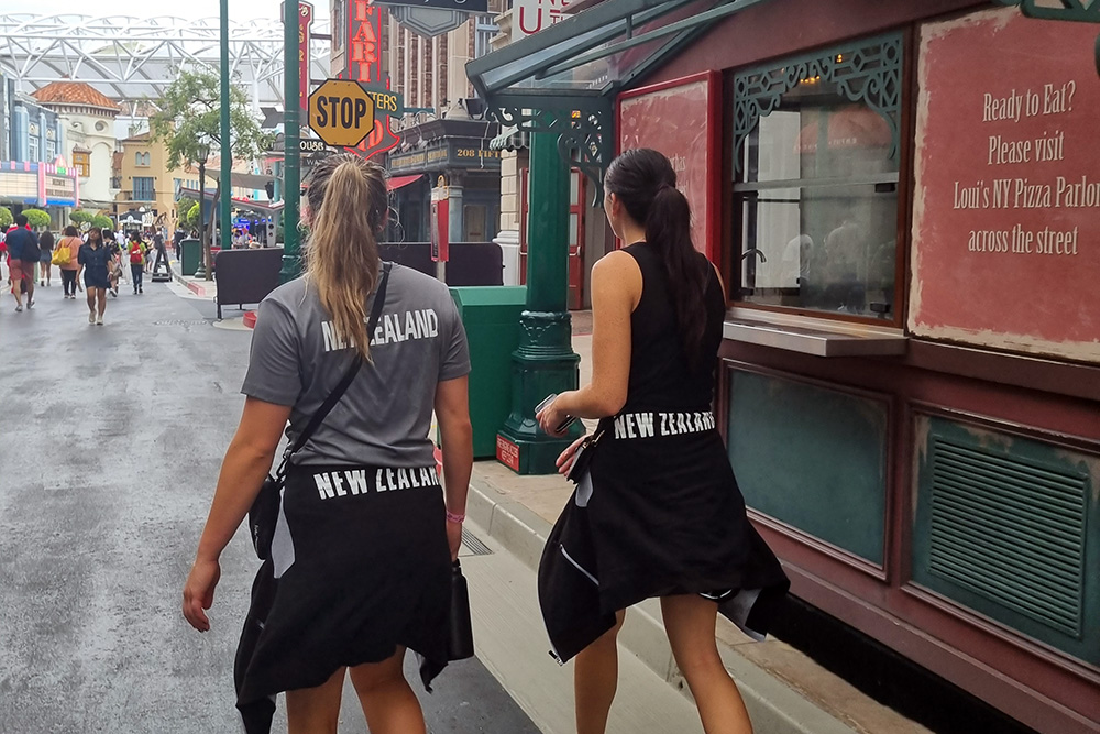 Two tall ferns player walking along a street in Singapore