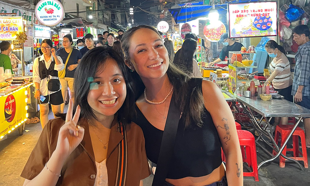 Cassidy and a work colleague posing for a photo at a nightmarket