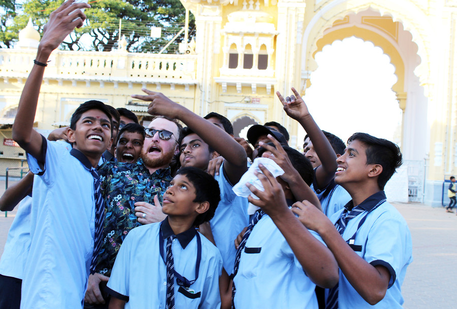 Chris Henderson taking a selfie with a group of school boys