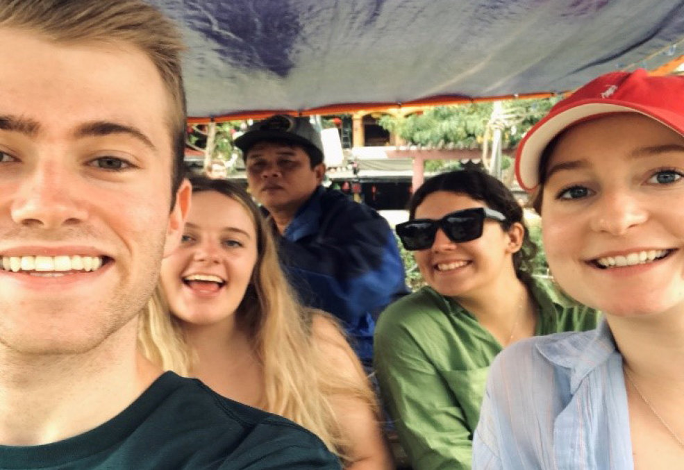 Ethan sitting in a tuk tuk with three other interns