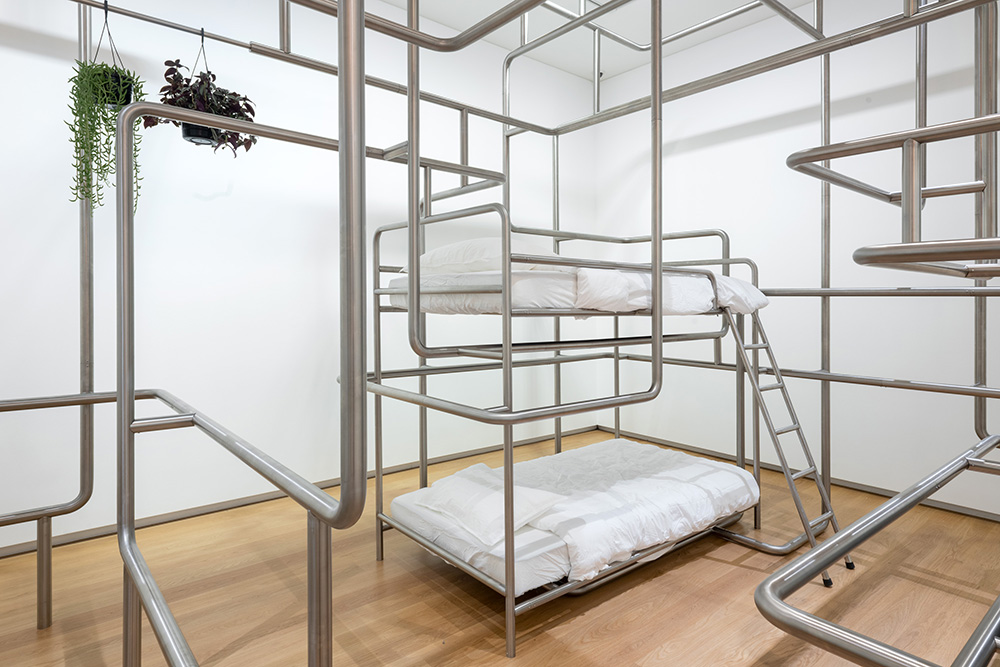 A section of 5 Rooms showing two beds intangled in a network of pipes