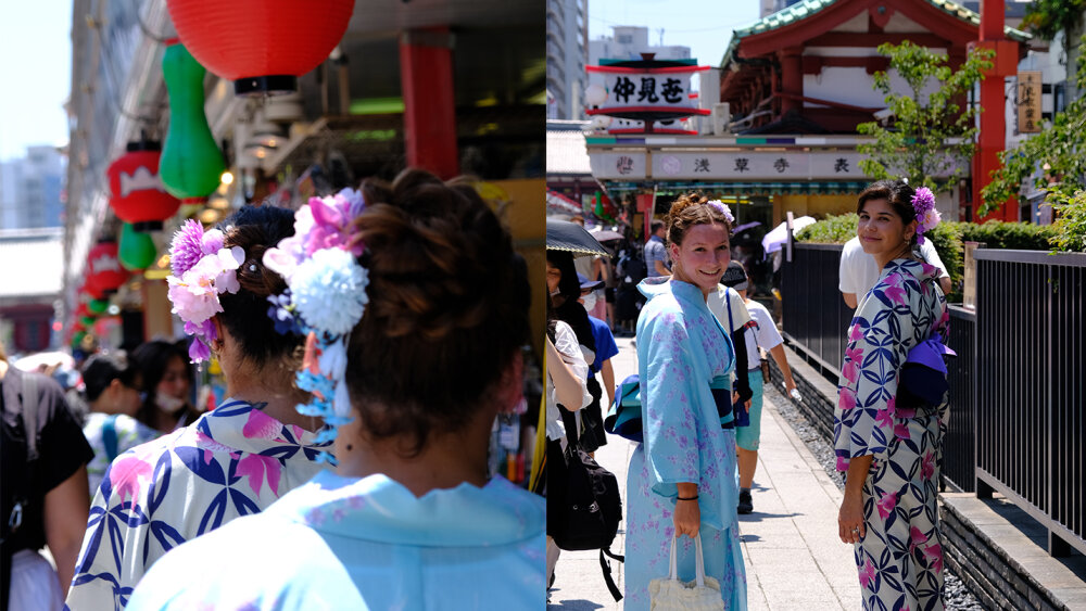 Two of the synchronised swimming team walking down a street wearing kimono