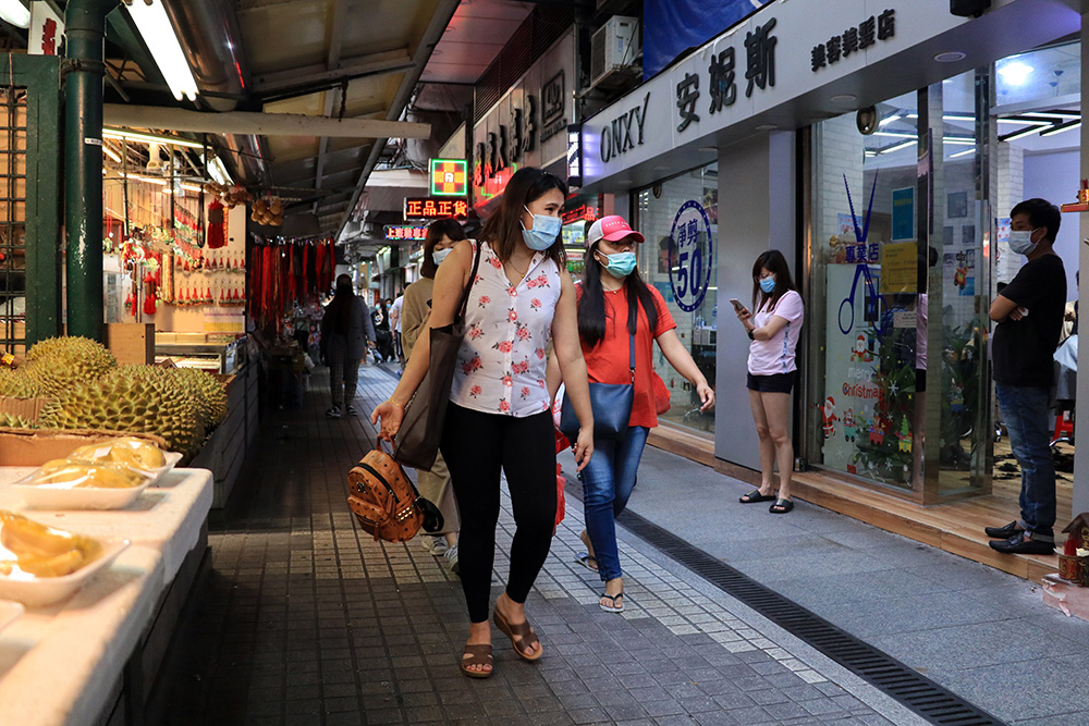 Women in masks walking down a street