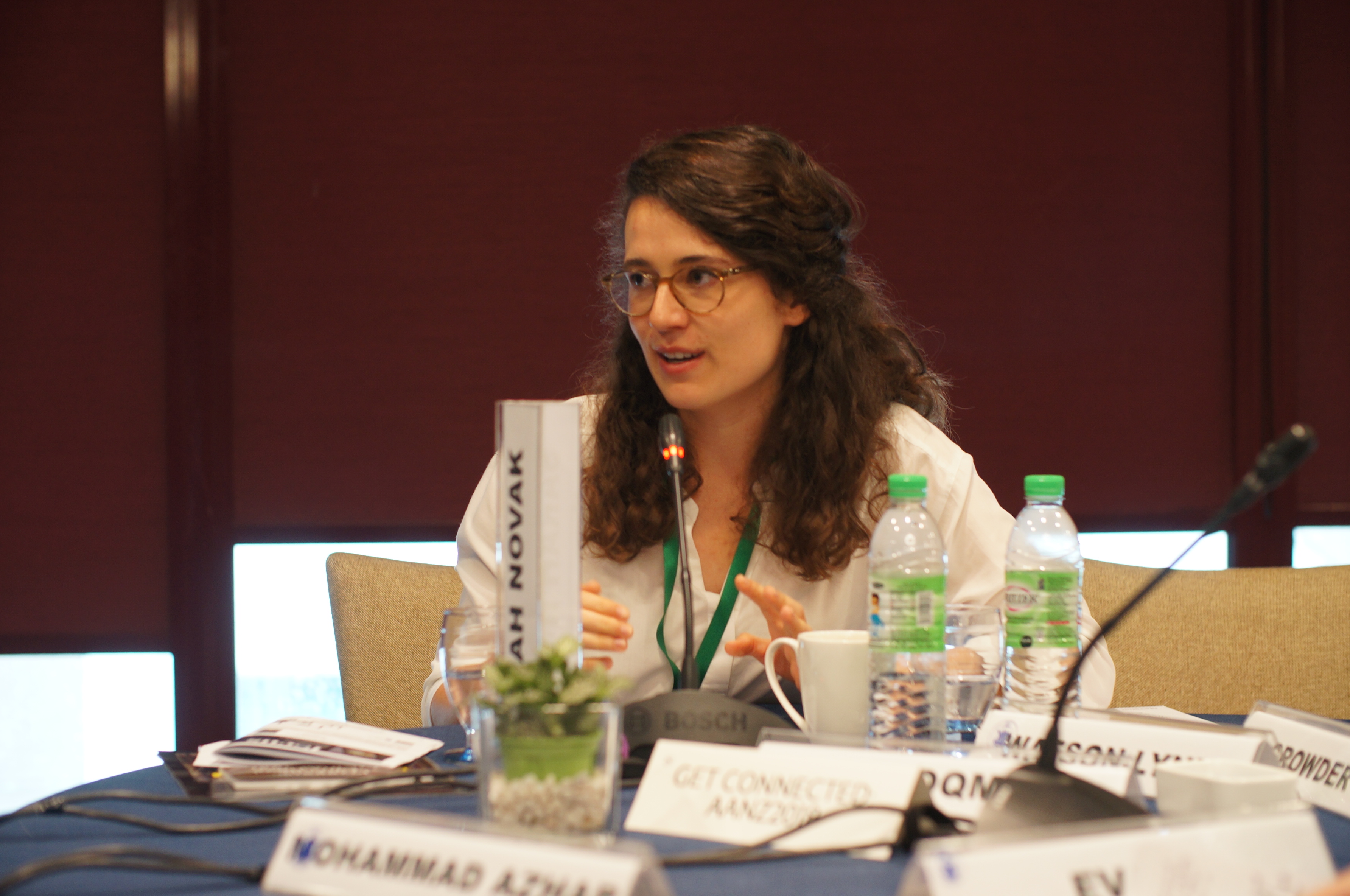 Sarah Novak sitting at a conference table