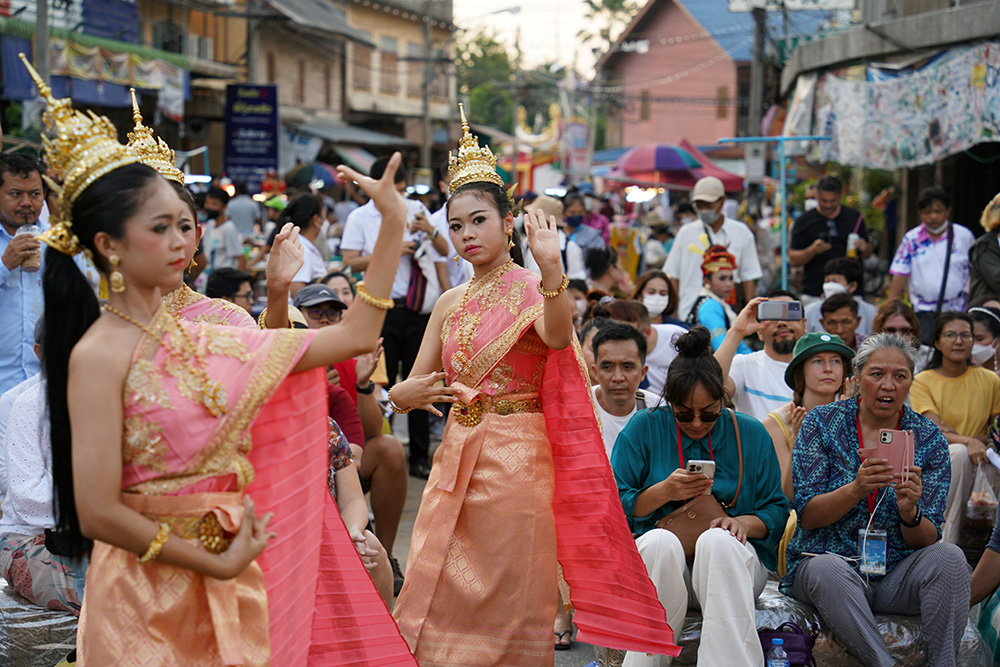 Dancers in traditional Thai costume perform on a street watched by the New Zealand and YBLI delegation