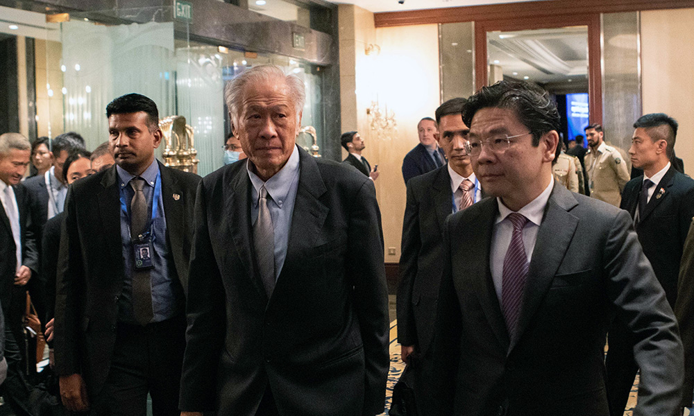 Singapore Minister of Defence Dr Ng Eng Hen walking through a crowded lobby 