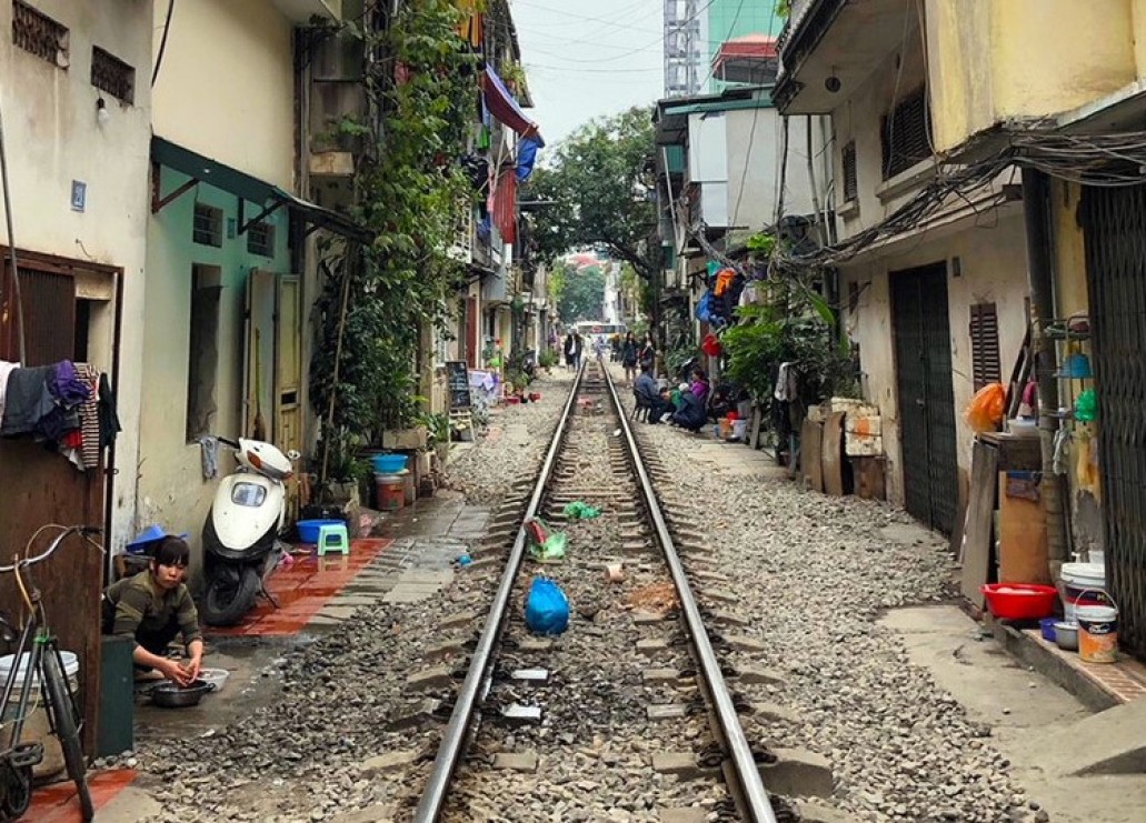 Railway lines passing through an urban environment with houses close to the tracks