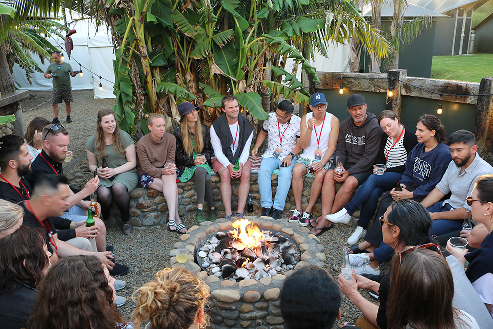 The entrepreneurs sitting round a fire pit 